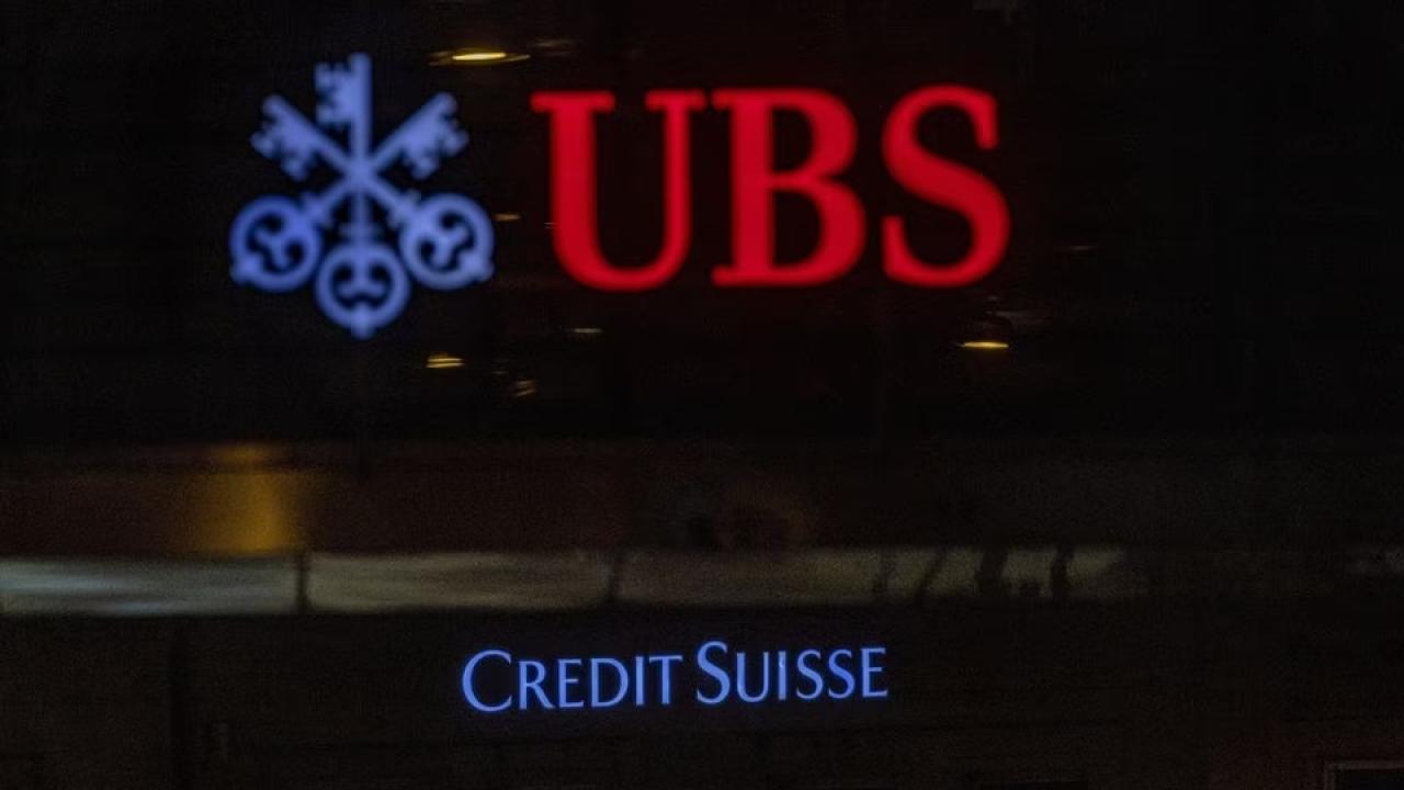 Logos of Swiss banks UBS and Credit Suisse are seen on an office building in Zurich, Switzerland.