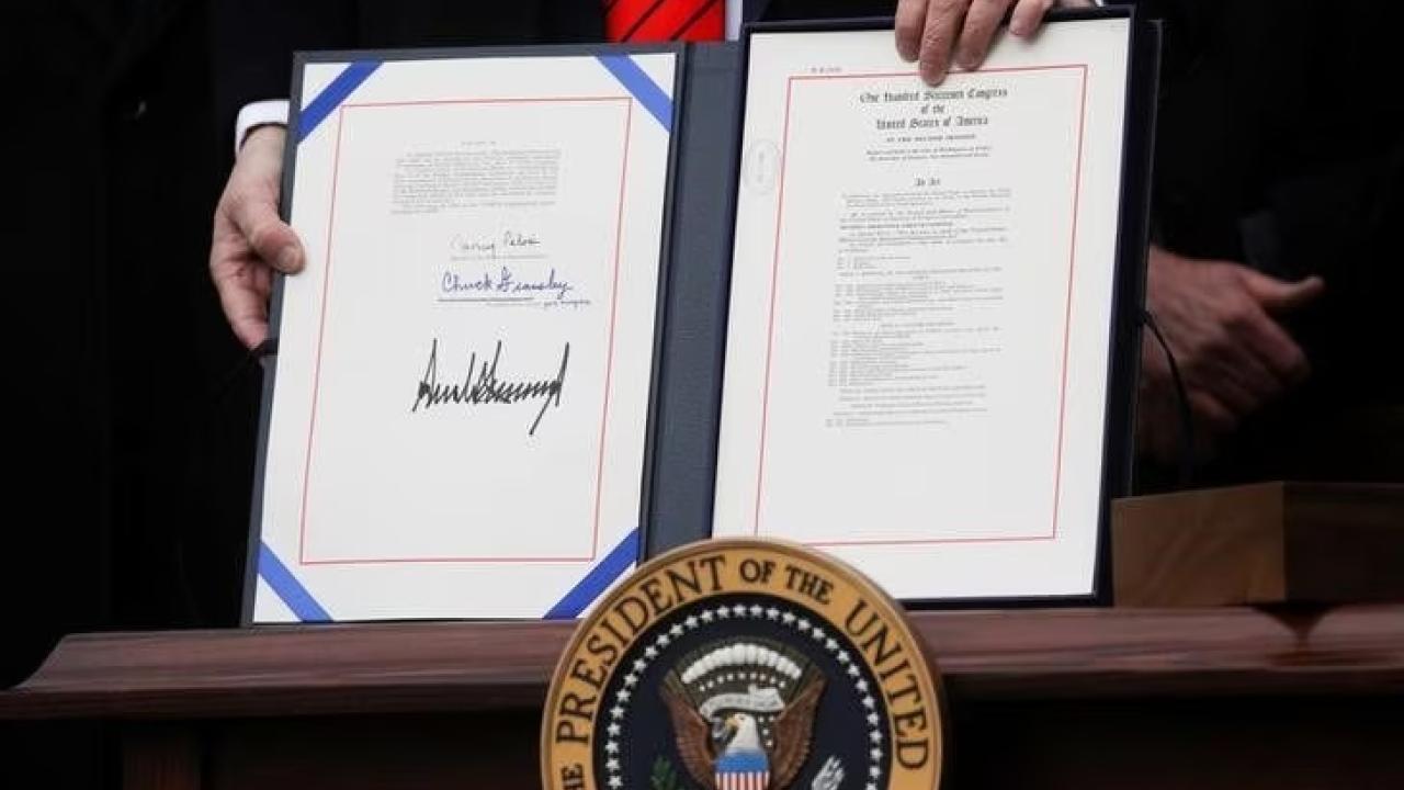 U.S. President Donald Trump shows off the United States-Mexico-Canada Trade Agreement (USMCA) after signing it on the South Lawn of the White House in Washington, U.S., January 29, 2020.