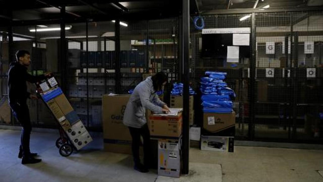 Employees prepare merchandise sold via eCommerce to be delivered to customers at retail chain Magazine Luiza S.A. store in Sao Paulo.