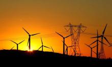 The sun rises behind windmills at a wind farm in Palm Springs, California.